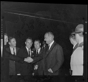President Johnson shakes hands with a supporter while Governor Peabody and Massachusetts State Treasurer Robert Crane looks on