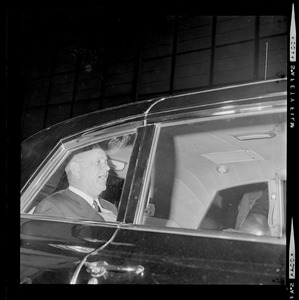 President Johnson in the back seat of a vehicle