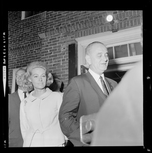 President Johnson talks with a reporter while walking out of N.E. Baptist Hospital