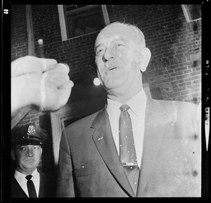 President Johnson talks with a reporter while walking out of N.E. Baptist Hospital