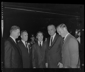 President Johnson standing with a group of men including Massachusetts State Treasurer Robert Crane, second from left, and Governor Peabody, far right