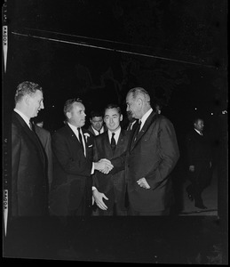 President Johnson shakes hands with Massachusetts State Treasurer Robert Crane while others looks on
