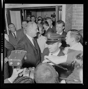 President Johnson talks with a reporter while walking out of N.E. Baptist Hospital, with Joan Kennedy at his side