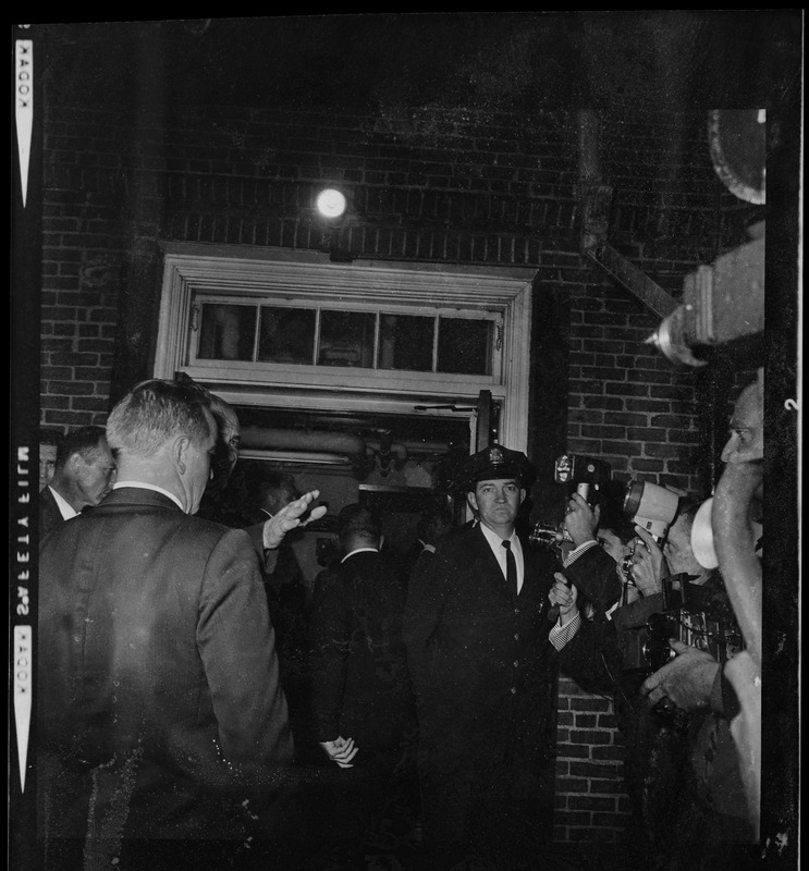 Officer standing at the door of N.E. Baptist Hospital