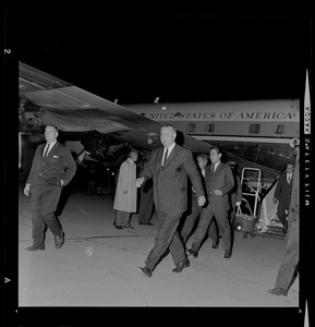 President Lyndon B. Johnson rushes to waiting car from his plane that had just touched down at Logan Airport