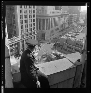 Policeman looking down at Post Office Square, prior to President Johnson's arrival