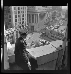 Policeman looking down at Post Office Square, prior to President Johnson's arrival