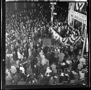 Bird's eye view of crowd listening to President Johnson speak from the stage in Post Office Square