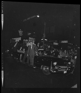 President Johnson waving from a vehicle