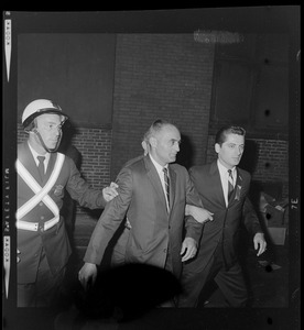 Lt. Gov. Francis X. Bellotti is led with a campaign aide and police officer after arriving to his Boston Headquarters on Franklin St.