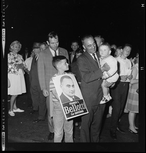 Lt. Gov. Bellotti holding a child while another younger boy looks up