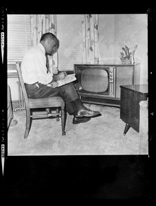 Lt. Gov. Bellotti sitting in front of television set