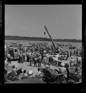 Crowd looks on as crane is used upon Gemini 9's arrival to Weymouth Naval Air Station