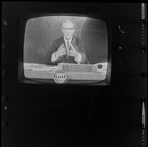 Newscaster seen on television reporting from Gemini Control