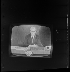 Newscaster seen on television reporting from Gemini Control