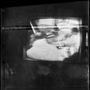 Scene of astronauts Stafford and Schirra preparing for Gemini 6 blastoff on television screen