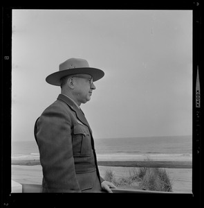 Man in uniform looks out along the coast line