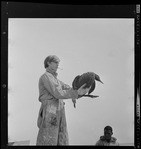 Job Corps worker holding up a cormorant
