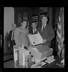 Massachusetts Secretary of the Commonwealth, John F. X. Davoren and another man giving Secretary's Citation award to a wounded Vietnam veteran