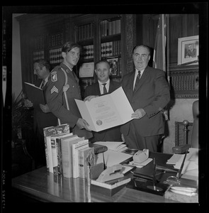 Massachusetts Secretary of the Commonwealth, John F. X. Davoren and another man giving a Secretary's Citation award to a wounded Vietnam vet