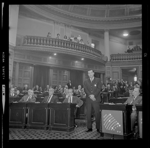 Officer standing in the aisle of the House chamber