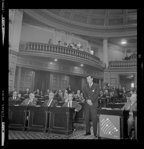 Officer standing in the aisle of the House chamber