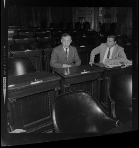 Representative H. Thomas Colo seated in the House with another man