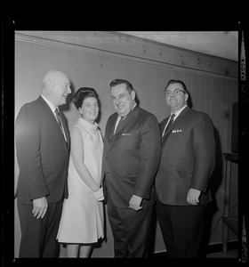 Three men and a woman pose for the camera