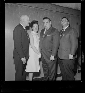 Three men and a woman pose for the camera