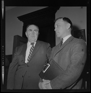 House Speaker John F. X. Davoren looks at Rep. H. Thomas Colo (D-Athol), who brought up a question of ethics, as they leave Speaker's Office in State House