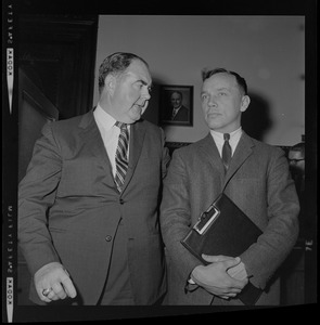 House Speaker John F. X. Davoren looks at Rep. H. Thomas Colo (D-Athol), who brought up a question of ethics, as they leave Speaker's Office in State House