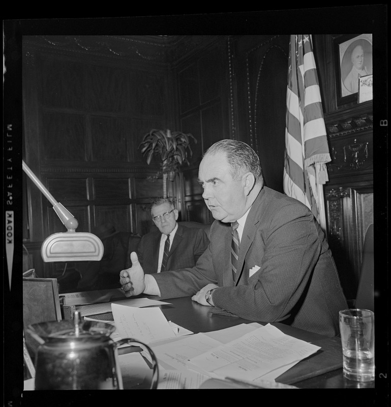 Speaker of the House John Davoren at his desk talking with someone off