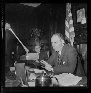 Speaker of the House John Davoren at his desk talking with someone off camera