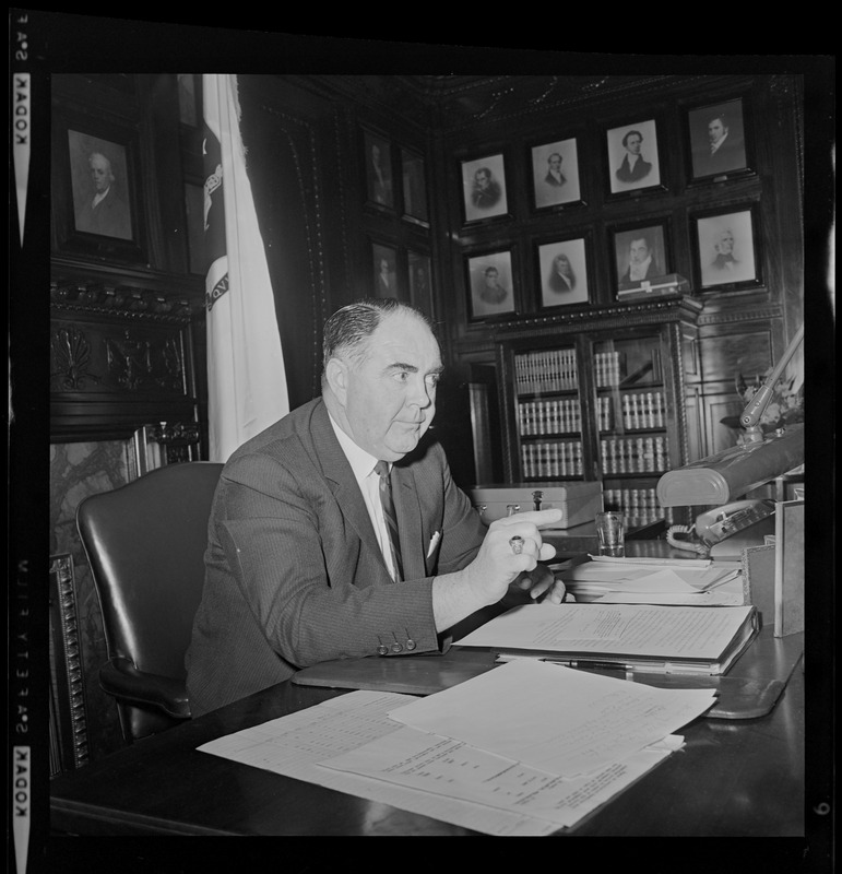 Speaker of the House John Davoren at his desk talking with someone off