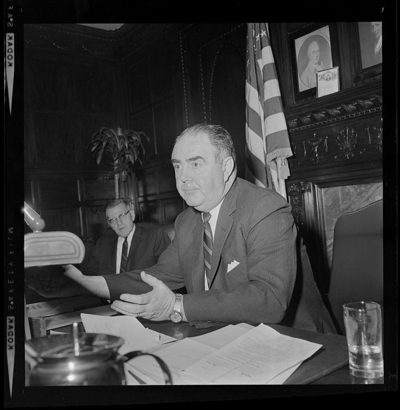 Speaker of the House John Davoren at his desk talking with someone off