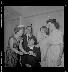 Supt. John R. West, seated, and surrounded by four people