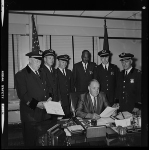 Police Commissioner Edmund McNamara reads directive to his new superintendent-in-chief and deputy superintendents during the first meeting at which the whole group has been present