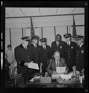 Police Commissioner Edmund McNamara reads directive to his new superintendent-in-chief and deputy superintendents during the first meeting at which the whole group has been present