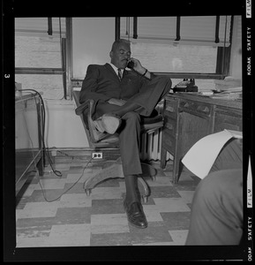 Dep. Supt. Herbert A. Craigwell seated at a desk and talking on the phone