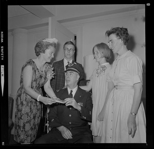 Supt. John R. West, seated, and surrounded by four people