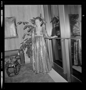 Mayor Kevin White's wife, Kathryn, in dress posing near a window during the opening of Boston City Hall