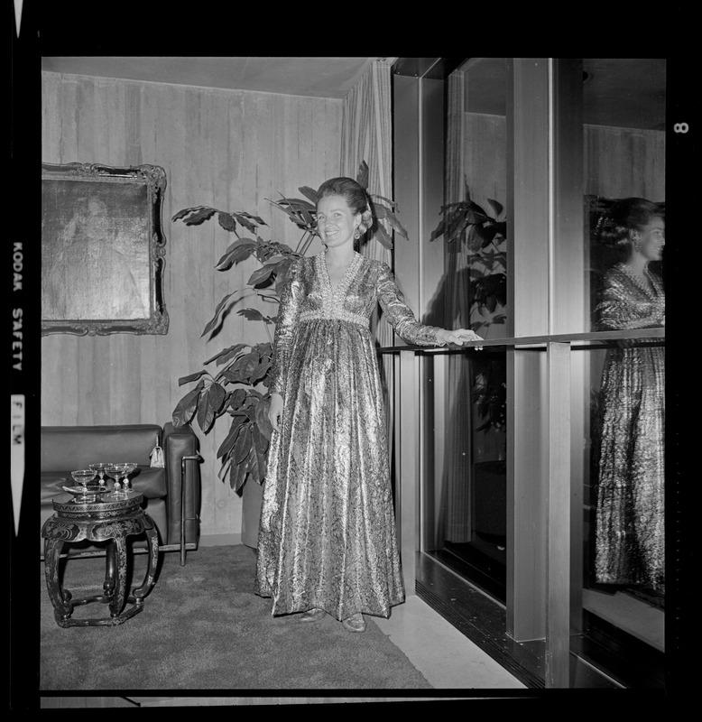 Mayor Kevin White's wife, Kathryn, in dress posing near a window during the opening of Boston City Hall