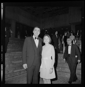 Woman and man posing on brick stairs at the opening of Boston City Hall
