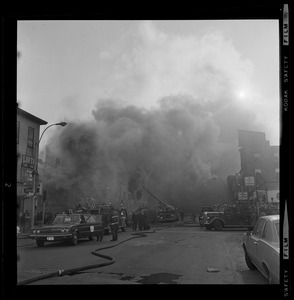 Large smoke cloud from fire covers the entire building of Blinstrub's Village nightclub