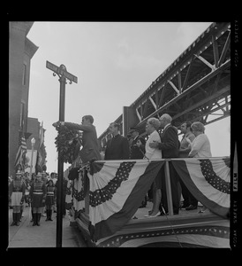 Official placing a wreath on William J. McNamara Sq. pole