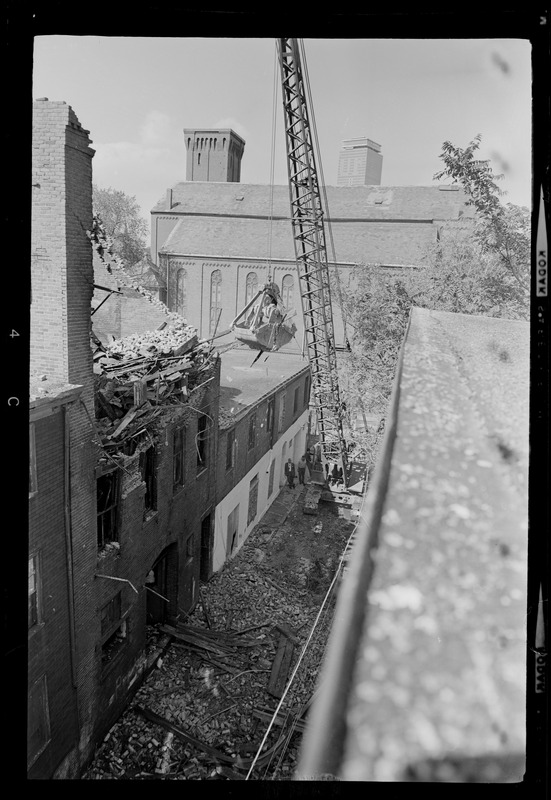 Crane removing debris after the fire caused a roof to collapse