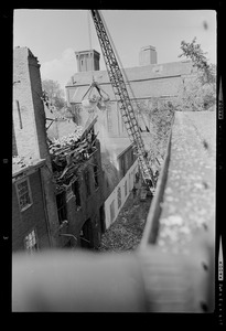 Crane removing debris after the fire caused a roof to collapse