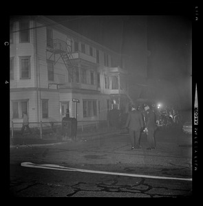 Officers standing in a street filled with smoke