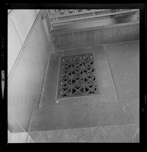 Grate on ground near building