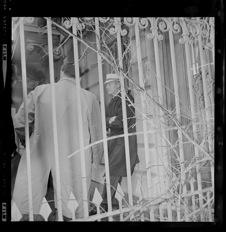 Photo taken through ironwork fence of B.U. President Dr. Arland F. Christ-Janer